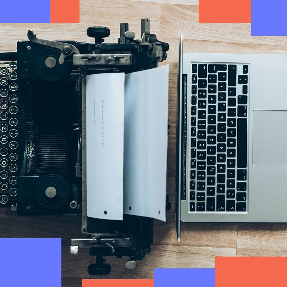 Overhead view of a vintage typewriter next to a modern laptop on a wooden desk, with bold blue and red geometric accents framing the corners — symbolising the shift from old to new.